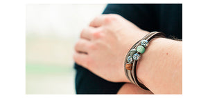 model wearing leather bracelet with gemstone beads and silver beads