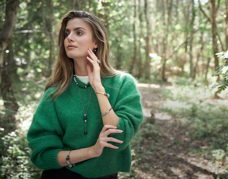 Trollbeads model in the forest wearing beautiful jewellery